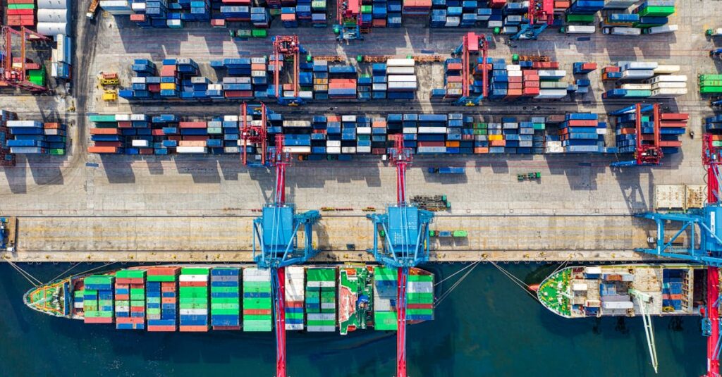 Drone shot capturing vibrant container ships and dock in North Jakarta port, Indonesia.
